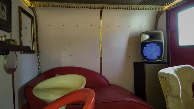 The curved sofa and retro furnishings at the red-door end of the lounge.