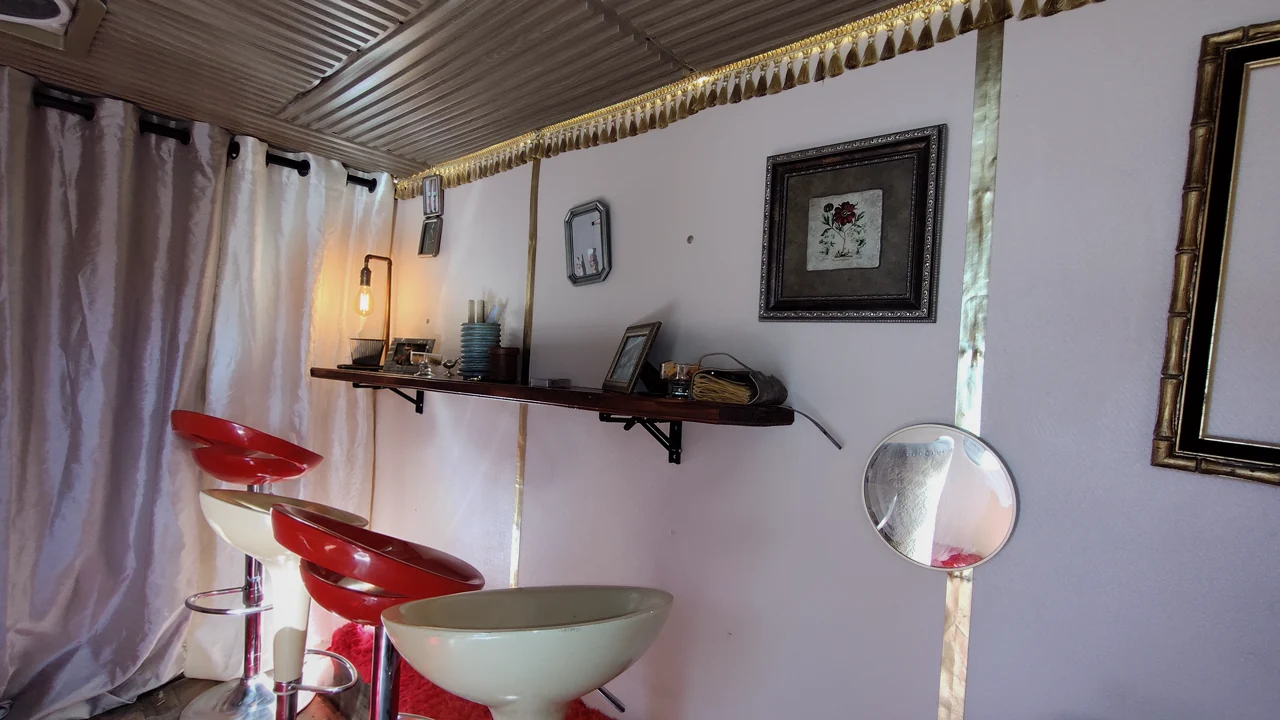 Framed pictures and vintage details along the lounge shelf.